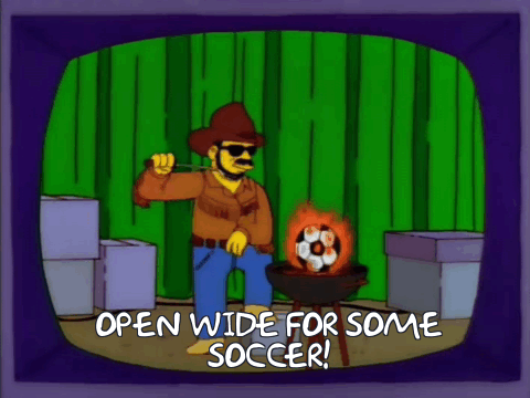 Opening scene from the NRA episode of the simpsons where a cowboy takes a flaming soccer ball off a grill and shouts 'Open wide for some soccer!'.